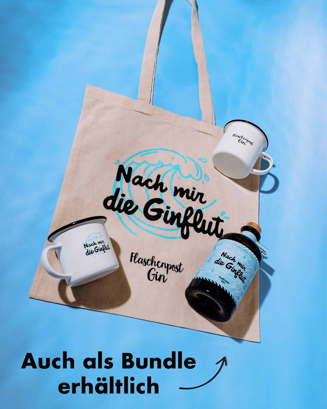 Die Ginflut Collection gibt es jetzt auch im Bundle mit Gin, Tasse, Jutebeutel und wahlweise sogar mit Tonic – das perfekte Picknick-Set. | Das Bundle liegt auf blauem Untergrund.